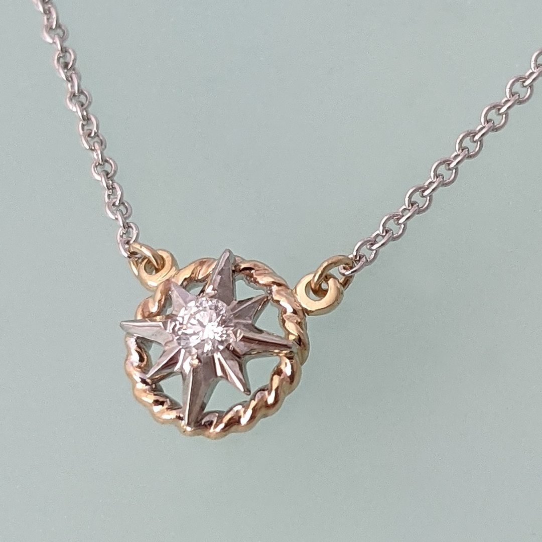 https://maggieleedesigns.com/cdn/shop/products/Maggie-Lee-Designs-compass-rose-petite-14K-two-tone-gold-rope-rim-diamond-necklace_2400x.png?v=1637263311